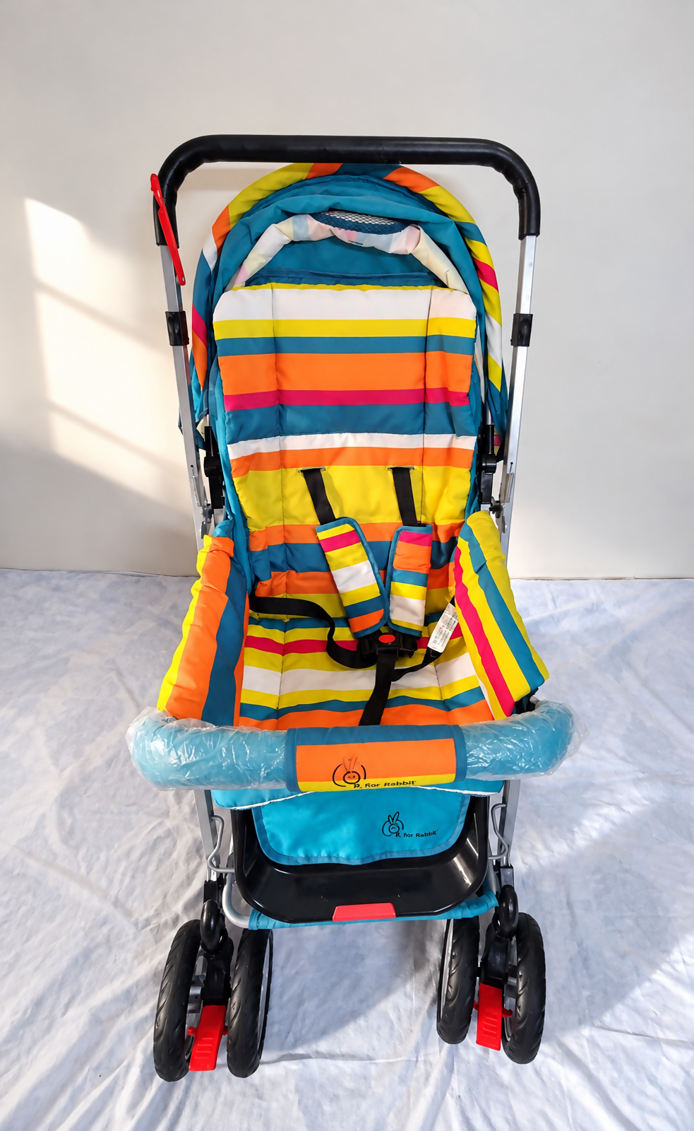 R FOR RABBIT Lollipop Lite Baby Pram B187 in Rainbow with reversible handle and reclining seat.