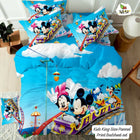Mickey Mouse and friends bedding set with blue sky and clouds design on a bed.