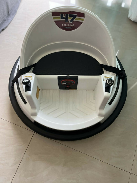 White and black hoverboard with '47 Sterling' branding on a tiled floor.