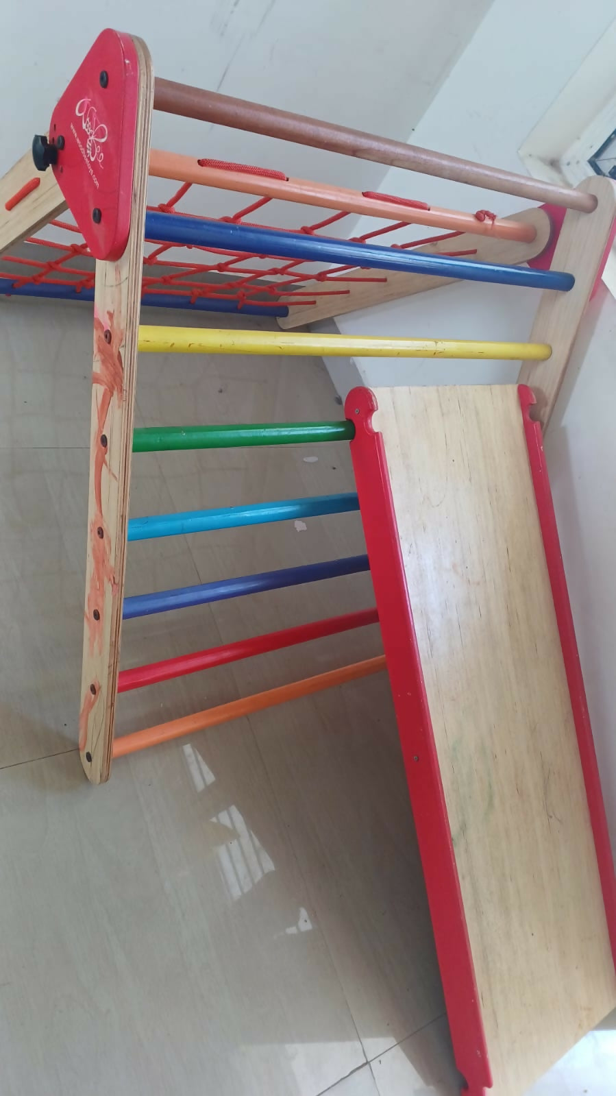Durable Woodbee Novus Pikler & Slide playset for toddlers, featuring a foldable design, adjustable slide, and high-quality wooden construction.
