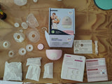 Breast pump parts and accessories on a brown surface