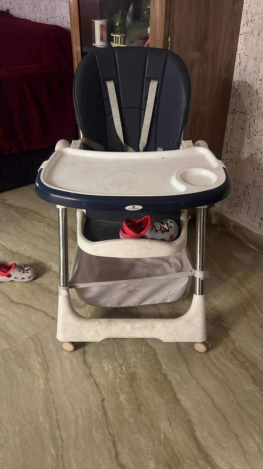 STAR AND DAISY Galaxy Star High Chair with comfortable padded seat, adjustable feeding tray, safety harness, sturdy frame, footrest, and easy-clean design for convenient baby and toddler mealtimes.