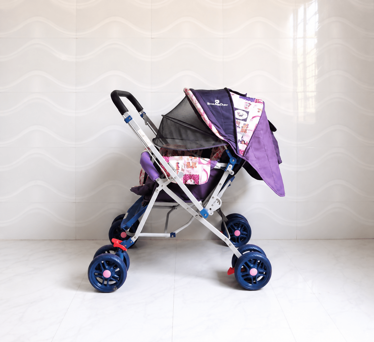 STAR & DAISY reversible baby stroller pram with mosquito net, reclining seat, reversible handle, safety harness, adjustable canopy, and comfortable travel support for babies.