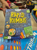 Hand holding a 'Rapid Rumble' game box with colorful dice illustration 