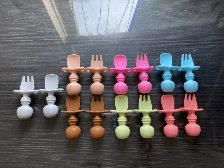 Silicone spoon and fork set made from food-grade BPA-free silicone with soft rounded edges, ergonomic handles, and a gentle design for safe self-feeding by babies and toddlers.