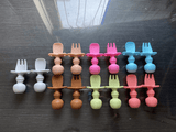 Silicone spoon and fork set made from food-grade BPA-free silicone with soft rounded edges, ergonomic handles, and a gentle design for safe self-feeding by babies and toddlers.