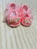 Handcrafted baby booties made from soft, baby-friendly fabric or yarn with a cozy, lightweight design to keep little feet warm, comfortable, and stylish.