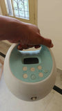 SPECTRA S-1 Plus Electric Breast Pump in White & Sky Blue with adjustable suction levels, massage mode, rechargeable battery, closed-system hygiene, and quiet operation for comfortable milk expression.