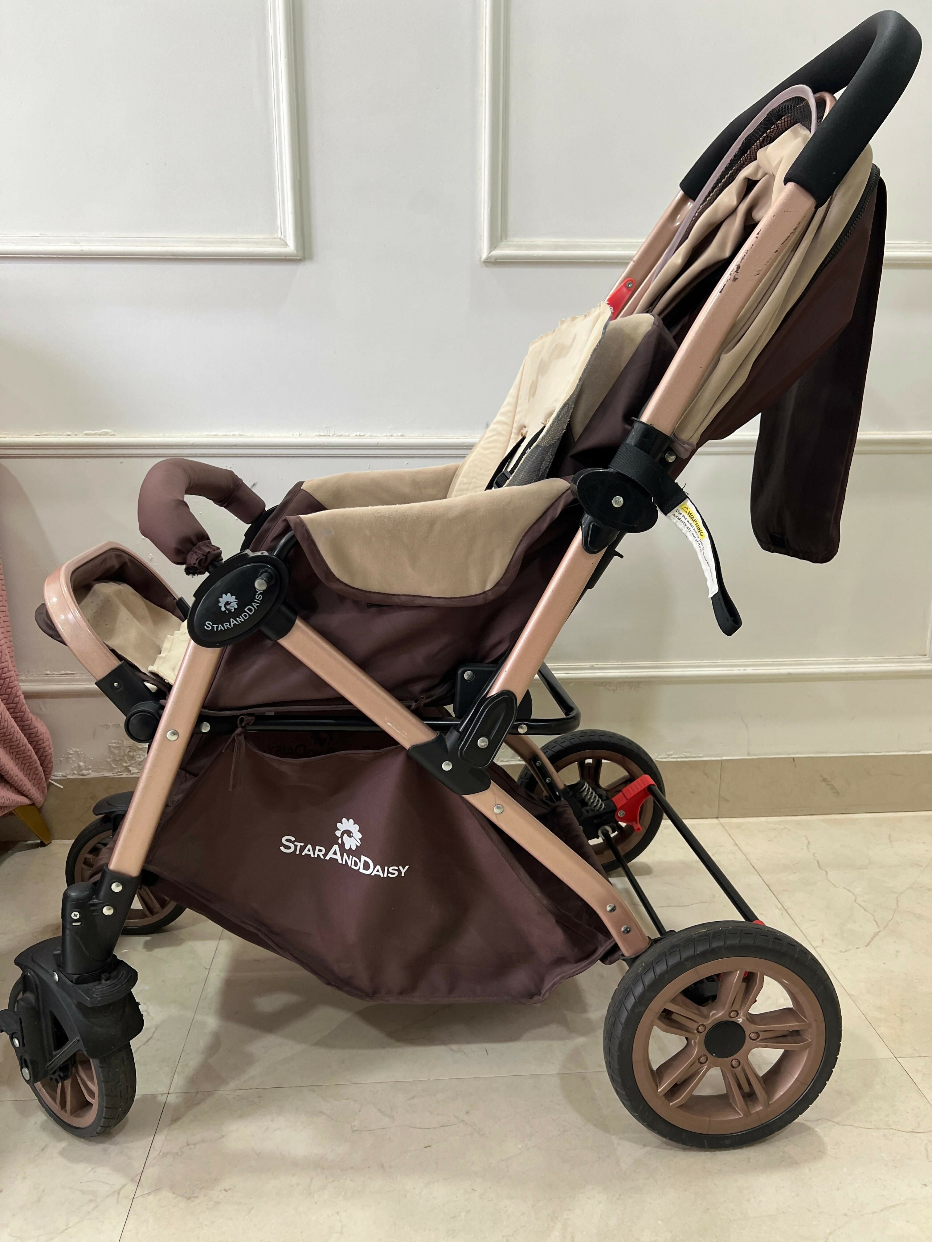 StarAndDaisy foldable baby stroller travel pram with reclining seat, sturdy wheels, safety harness, adjustable canopy, and compact foldable design for comfortable baby travel.