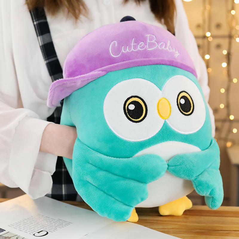 Plush owl toy with a purple hat 