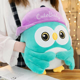 Plush owl toy with a purple hat 
