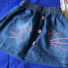 Blue denim shorts with pink embroidered designs 
