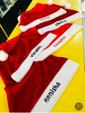 Red Santa hats with white bands featuring names on a yellow surface