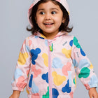 Child wearing a colorful jacket with cartoon character patterns 