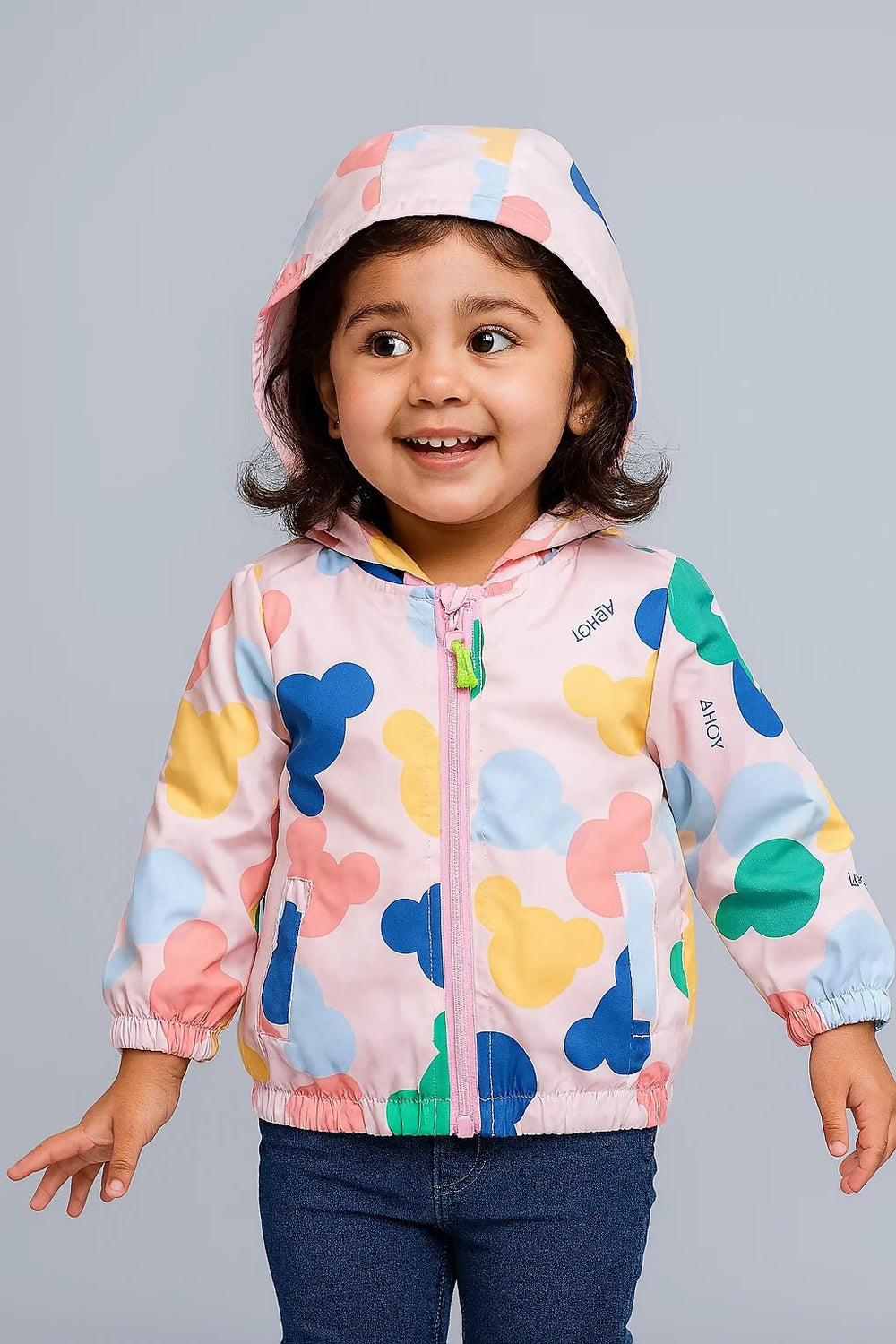 Child wearing a colorful jacket with cartoon character patterns 