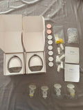 Théa wearable electric breast pump with hands-free design, compact milk collection cups, adjustable suction, and portable pumping support for breastfeeding mothers.