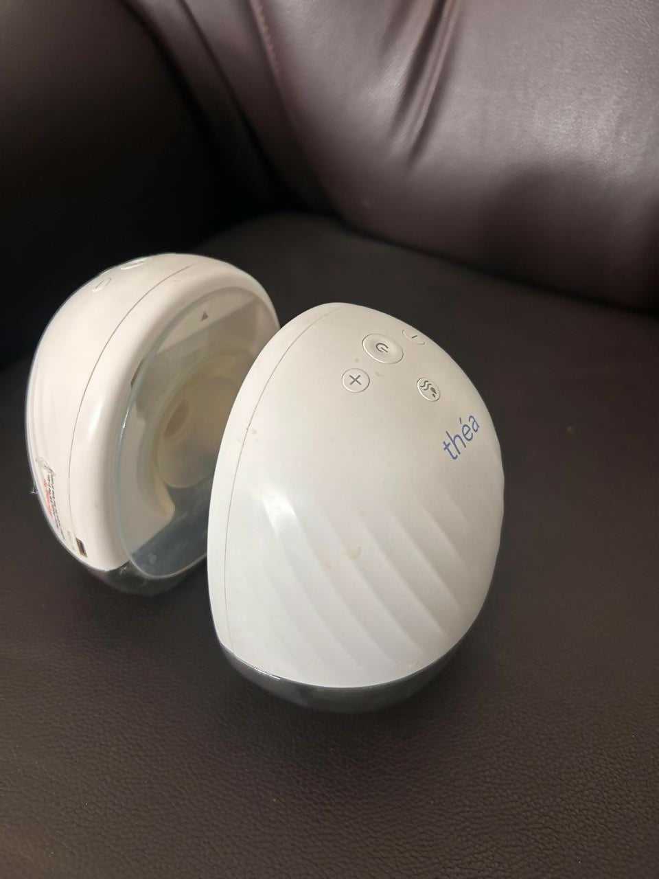 Théa wearable electric breast pump with hands-free design, compact milk collection cups, adjustable suction, and portable pumping support for breastfeeding mothers.