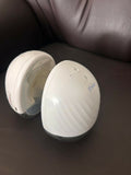 Théa wearable electric breast pump with hands-free design, compact milk collection cups, adjustable suction, and portable pumping support for breastfeeding mothers.