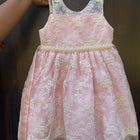 Adorn your baby girl in this elegant Pearl and Lace Work Frock, perfect for making precious memories!






