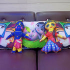 Colorful plush toys and pillows with cartoon characters 