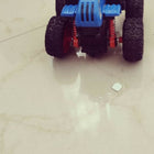 Toy car with blue and black design on a light gray surface