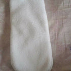 White textured object on a patterned fabric background