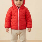 Vibrant red puffer jacket with hood for kids, featuring warm padded insulation, lightweight construction, front zip closure, and a cozy design for comfortable winter wear.