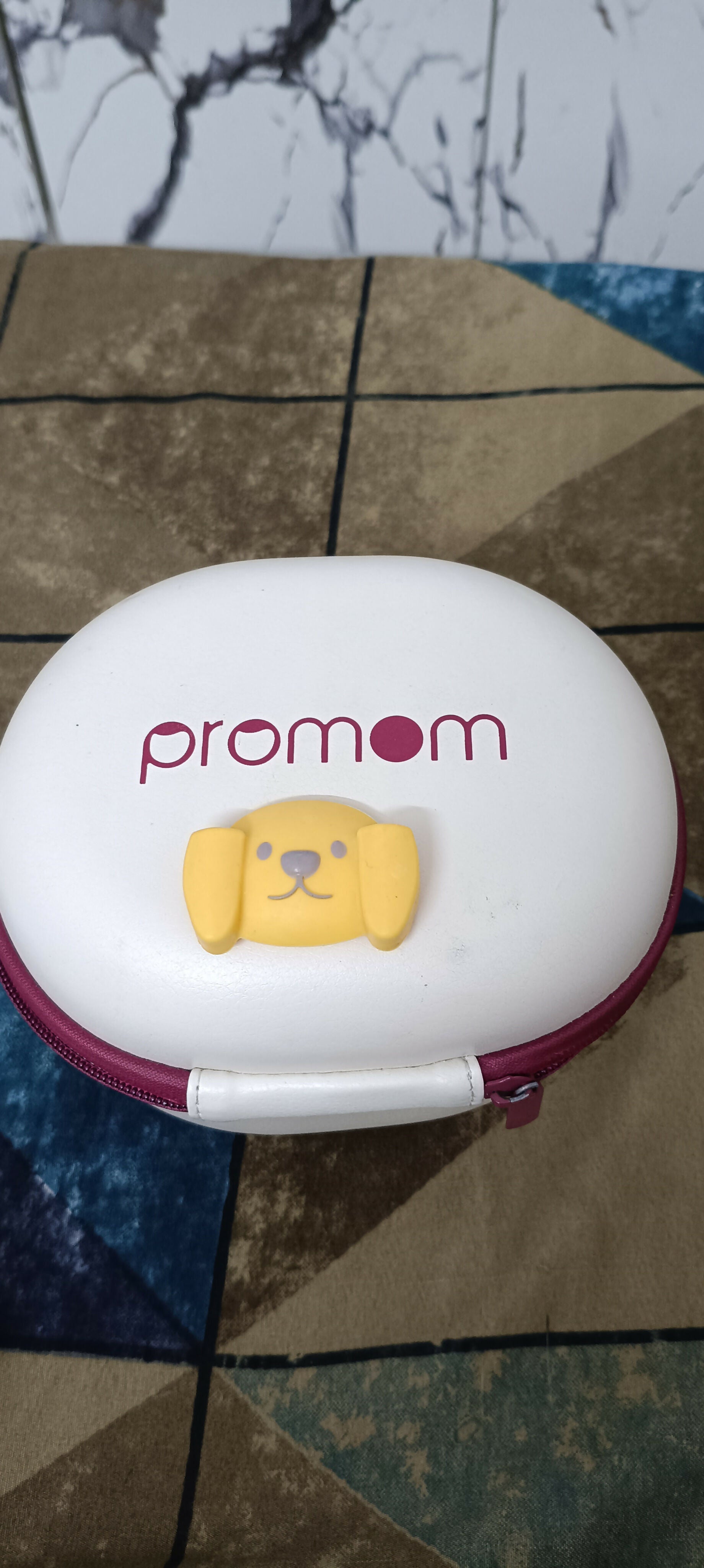 PROMOM electric wearable breast pump with hard case, hands-free design, compact milk collection cups, adjustable suction, and portable pumping support for breastfeeding mothers.