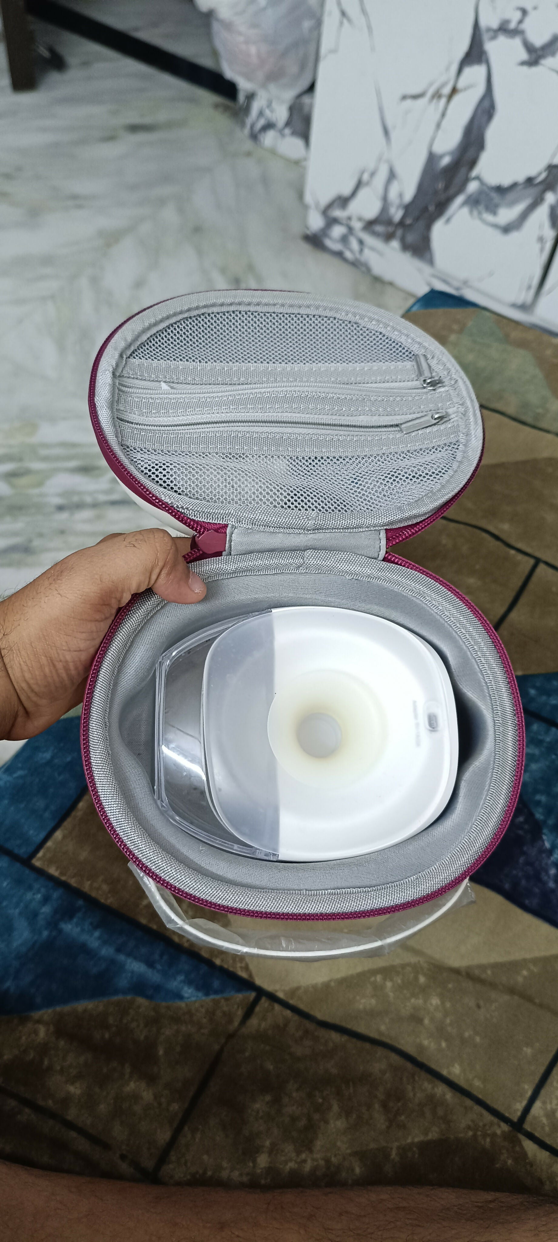 PROMOM electric wearable breast pump with hard case, hands-free design, compact milk collection cups, adjustable suction, and portable pumping support for breastfeeding mothers.