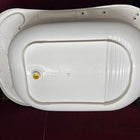 White plastic basin with a yellow dot on a dark surface