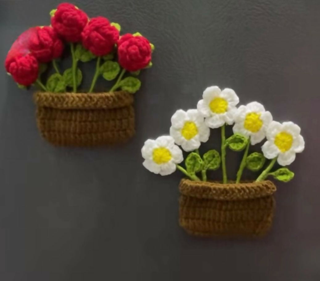 Two crochet flower pots with red flowers and white flowers
