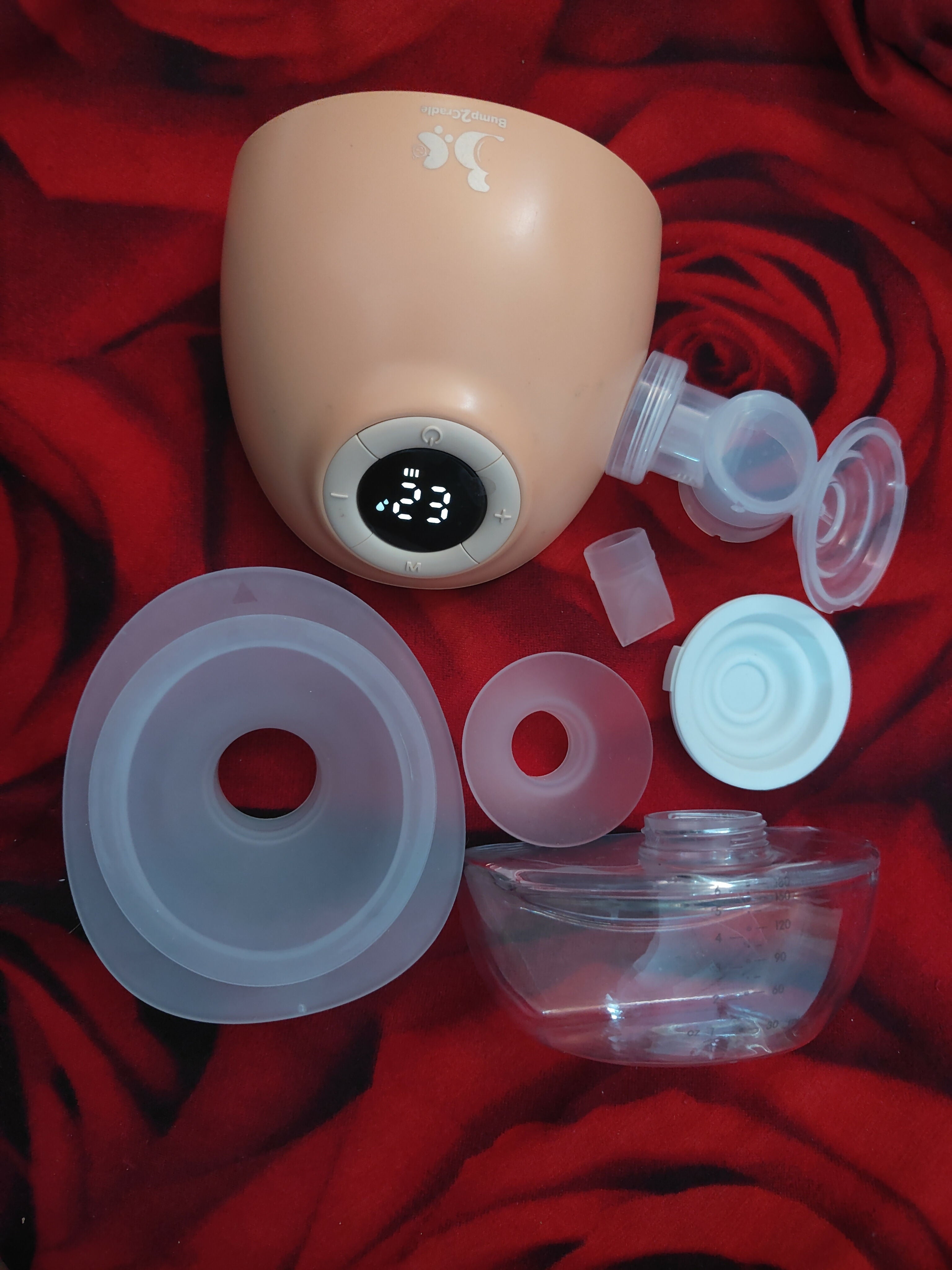 Baby bottle with accessories on a red blanket