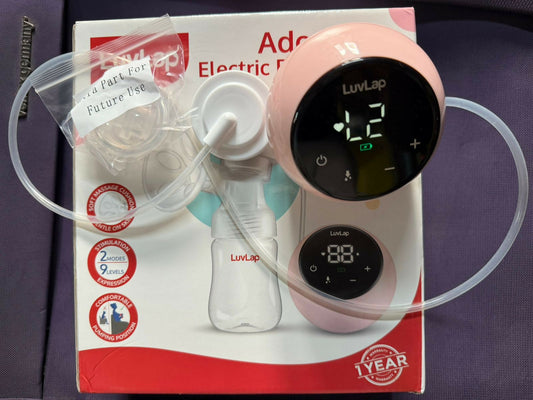 Electric breast pump with clear tubing on a purple background