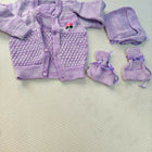 Purple baby outfit with cardigan, pants, and booties on a light background