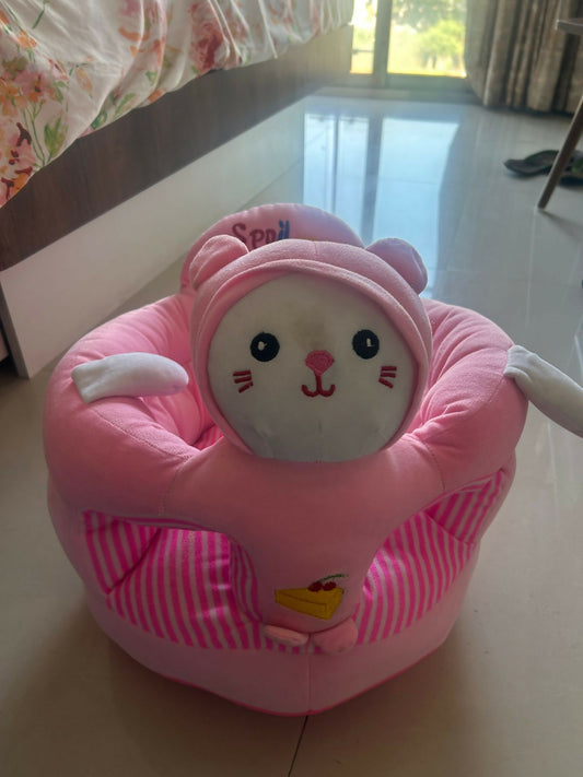 Pink cartoon character seat on a floor