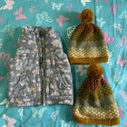 Floral-patterned pouches and a yellow textured bag on a blue fabric background with butterfly designs.