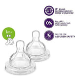 Two clear baby bottle nipples with safety certification logos on a white background