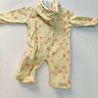 Yellow baby romper with pink floral pattern on a light gray background