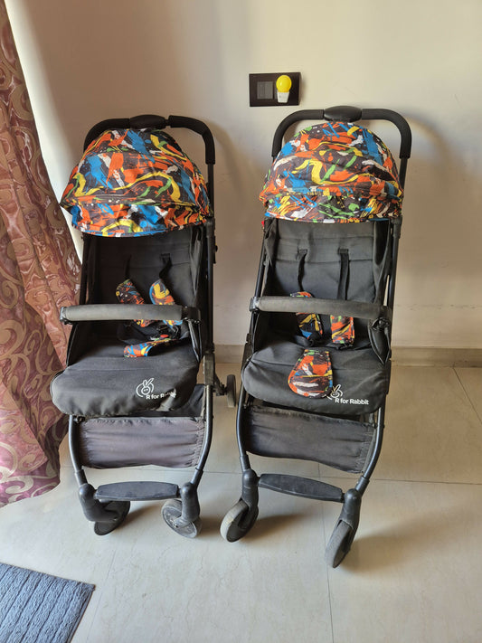 Two baby strollers with colorful covers