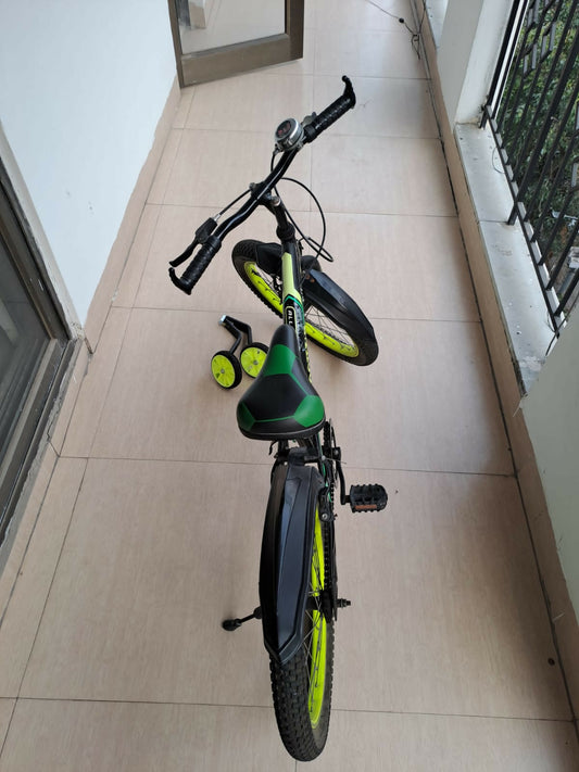 Children's bicycle with training wheels on a tiled floor