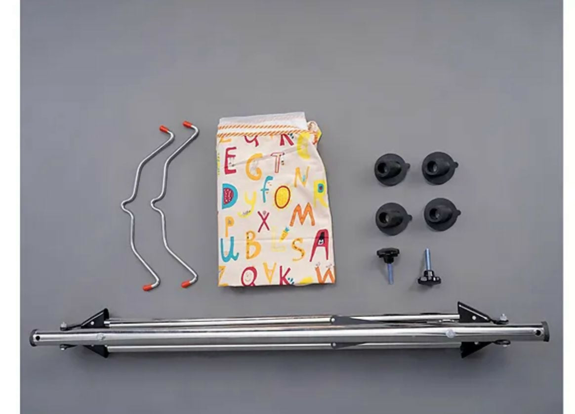 Collection of bike components including a metal frame, hangers, and small parts on a gray background.