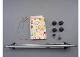 Collection of bike components including a metal frame, hangers, and small parts on a gray background.