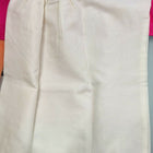 White skirt with gold trim on a pink fabric background