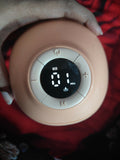 Pink electronic device with digital display held by a hand on a red background