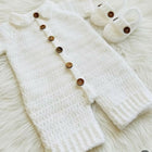 White knitted baby outfit with wooden buttons 