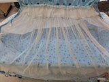 Baby crib with a blue and white canopy