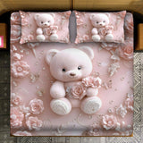 Pink teddy bear and floral design on a bedspread with matching pillows.