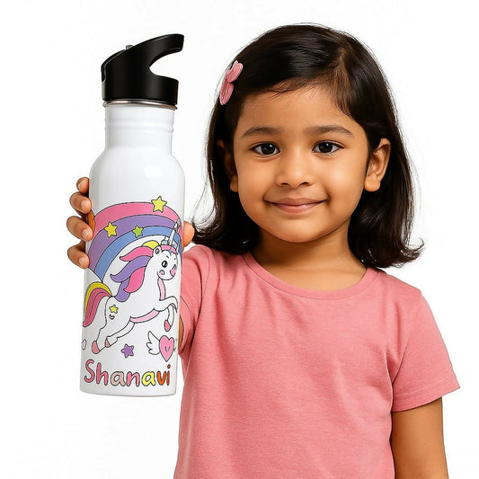 Child holding a white water bottle with a unicorn design and 'Shanavi' text.