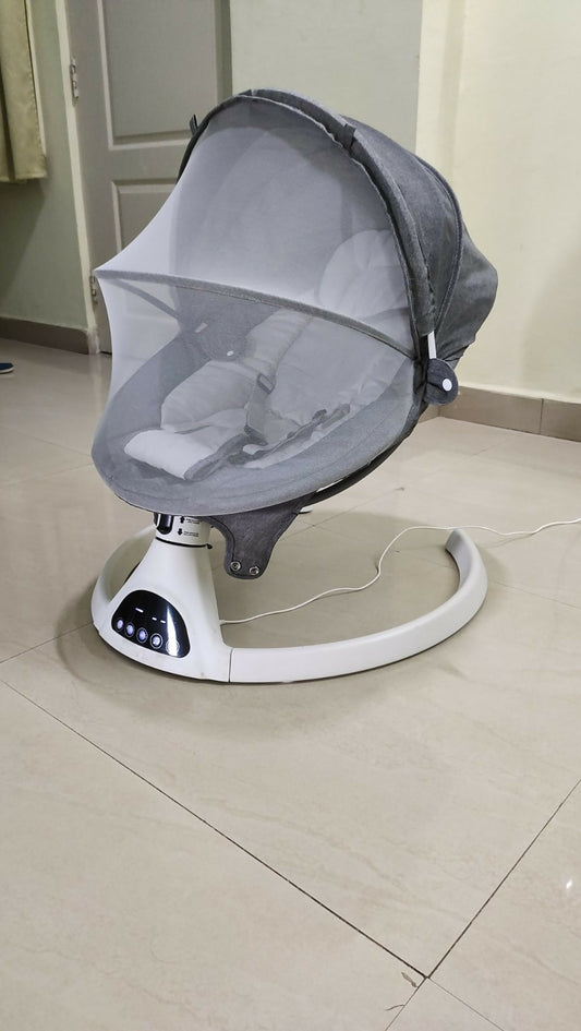 Soothe your baby to sleep with the Automatic Electric Rocker with Mosquito Net, offering gentle rocking motion and bug protection for peaceful slumber.