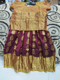 Traditional outfit with a gold blouse and maroon skirt 